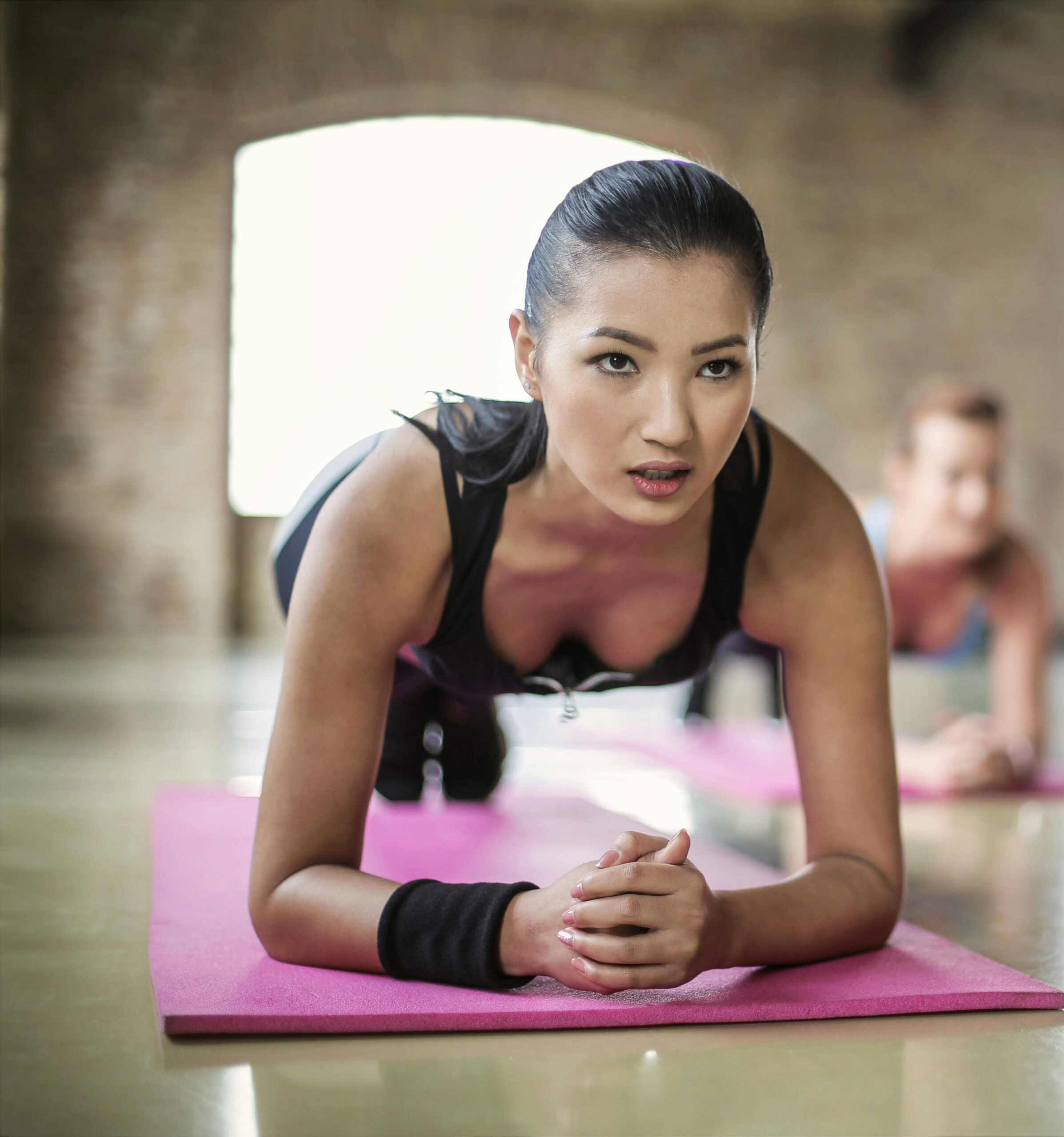 group of women exercise using dumbbells